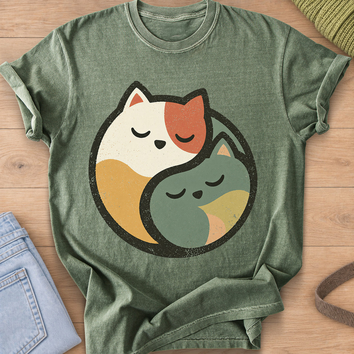 Two sleeping cats curled together to form a round yin yang circle on a Moss T-Shirt