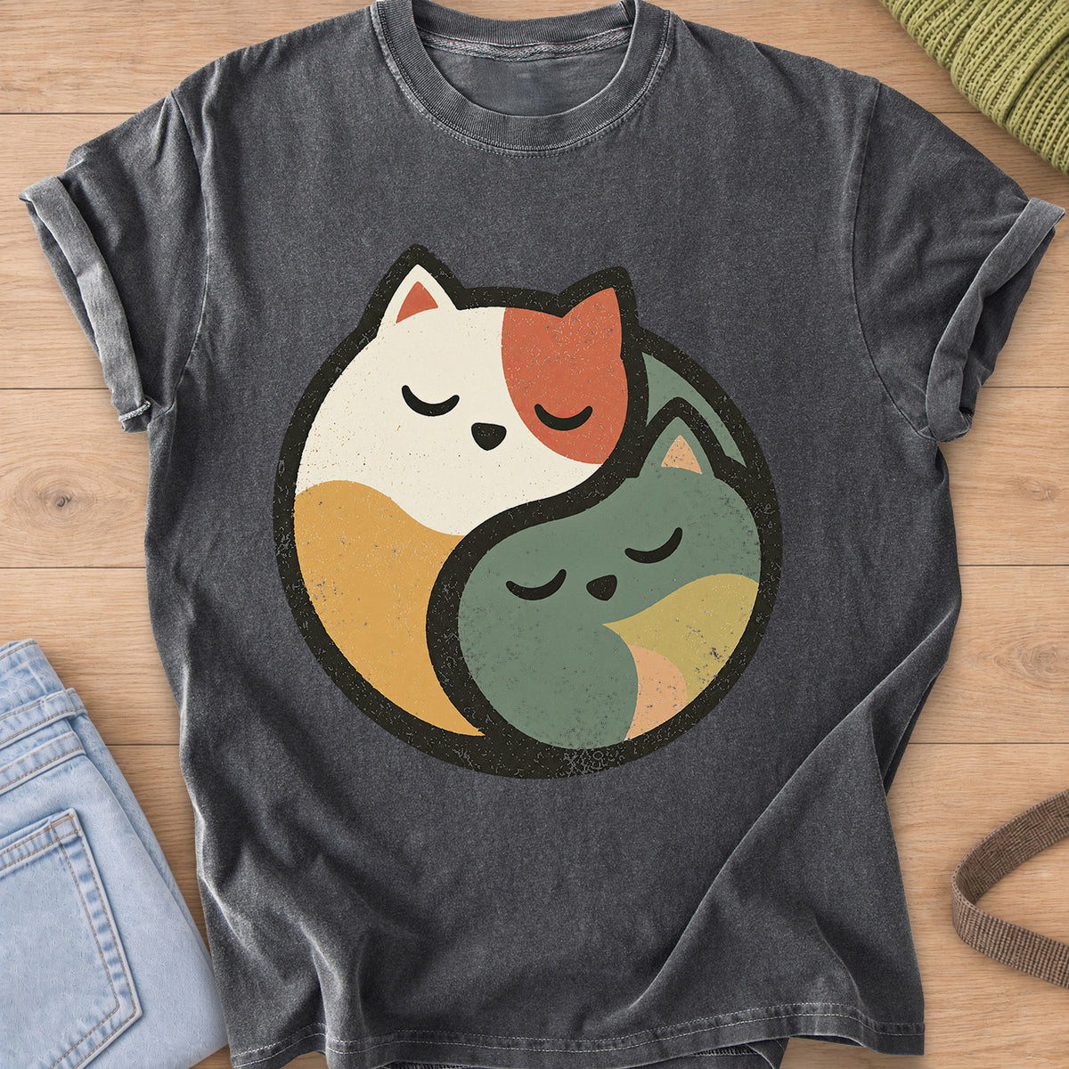 Two sleeping cats curled together to form a round yin yang circle on a Pepper T-Shirt