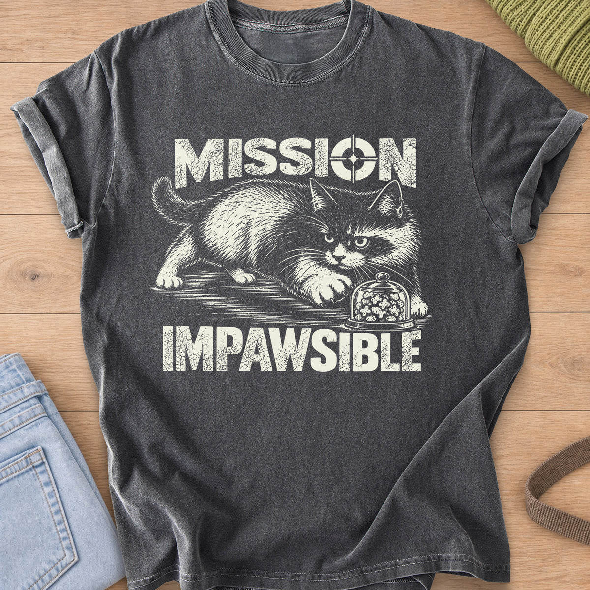 Fluffy cat sneaking toward a glass dome of treats under "Mission Impawsible", cream ink on a Pepper T-Shirt