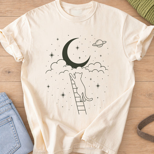 Cat on a ladder reaching up to a crescent moon in clouds, with stars and a planet, dark charcoal ink on an Ivory T-Shirt