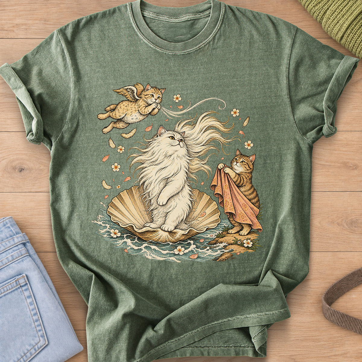 Fluffy cat on a seashell in the waves with a winged cat and a tabby holding a cloth on a Moss T-Shirt