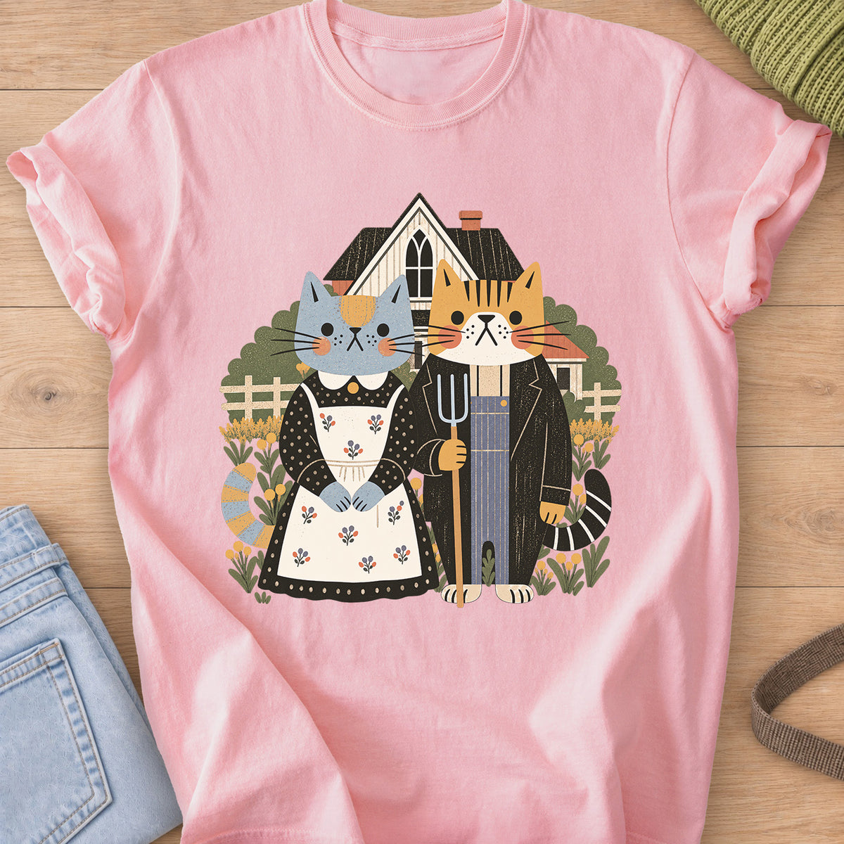 Two cats posed as American Gothic with pitchfork, apron, farmhouse and flowers on a Blossom T-Shirt