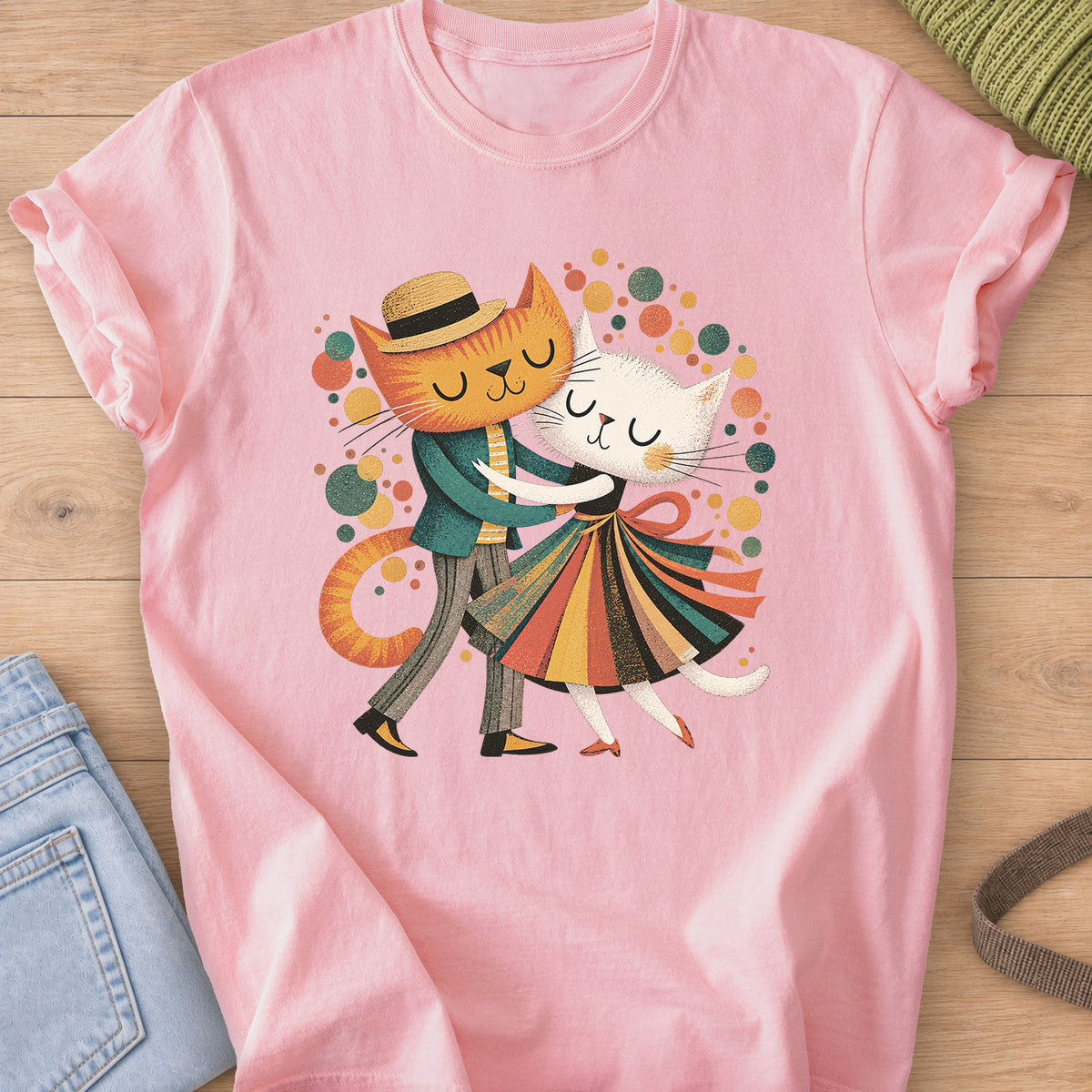 Two cats dance cheek to cheek, one in a straw hat, one in a striped skirt, amid dots on a Blossom T-Shirt
