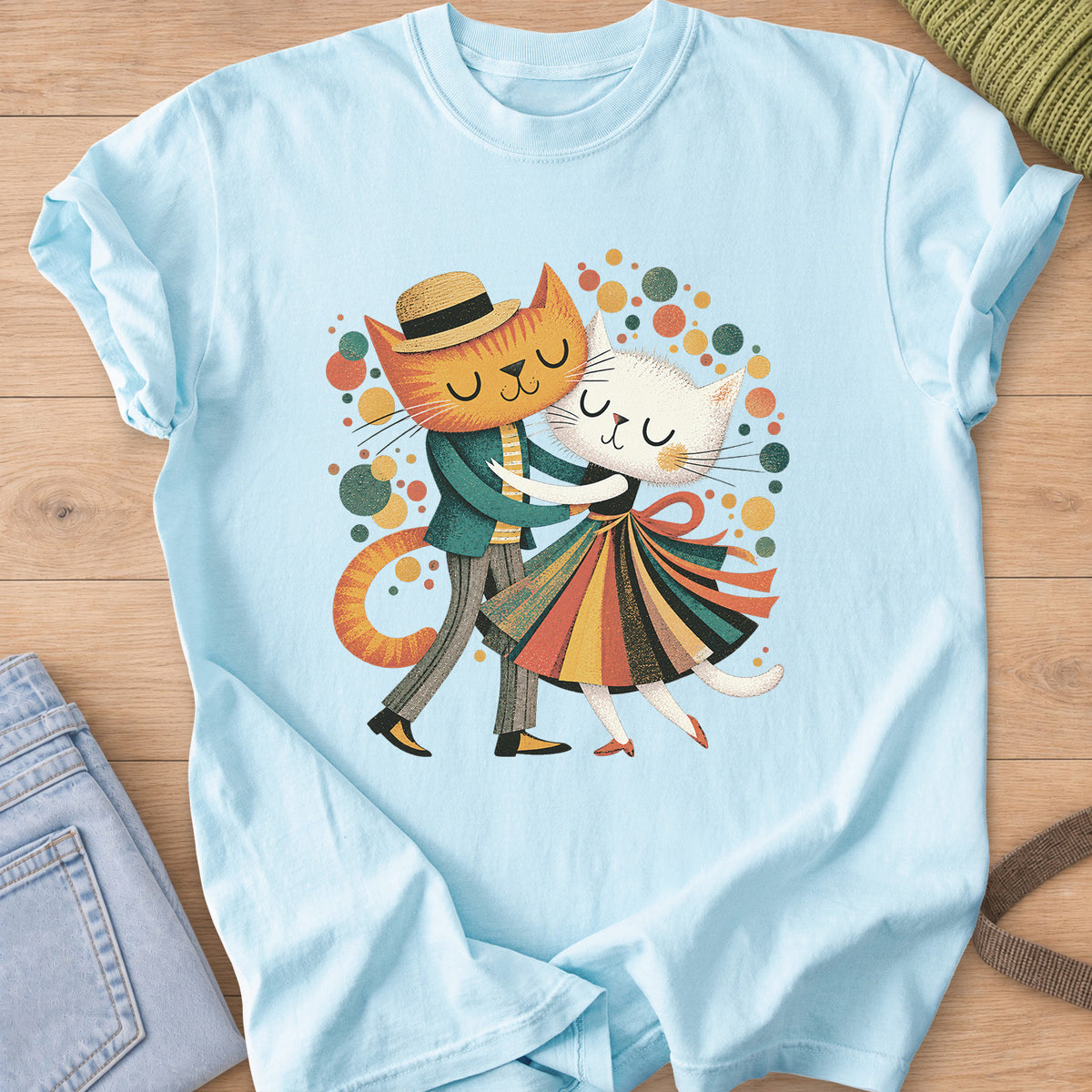 Two cats dance cheek to cheek, one in a straw hat, one in a striped skirt, amid dots on a Chambray T-Shirt