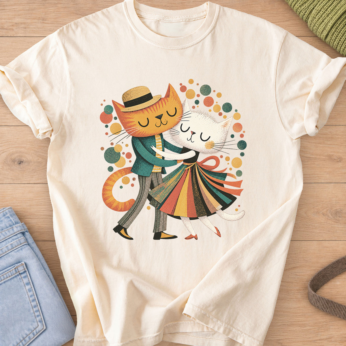 Two cats dance cheek to cheek, one in a straw hat, one in a striped skirt, amid dots on an Ivory T-Shirt