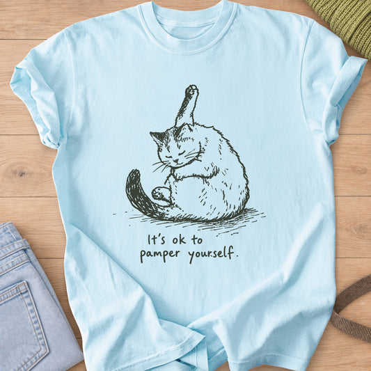 Fluffy cat grooming with one hind leg up in the air, "It's ok to pamper yourself.", dark charcoal ink on a Chambray T-Shirt
