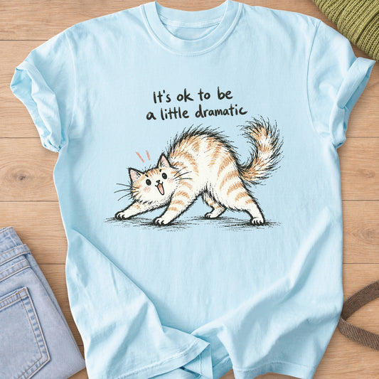 Startled fluffy cat arching its back beneath "It's ok to be a little dramatic" on a Chambray T-Shirt