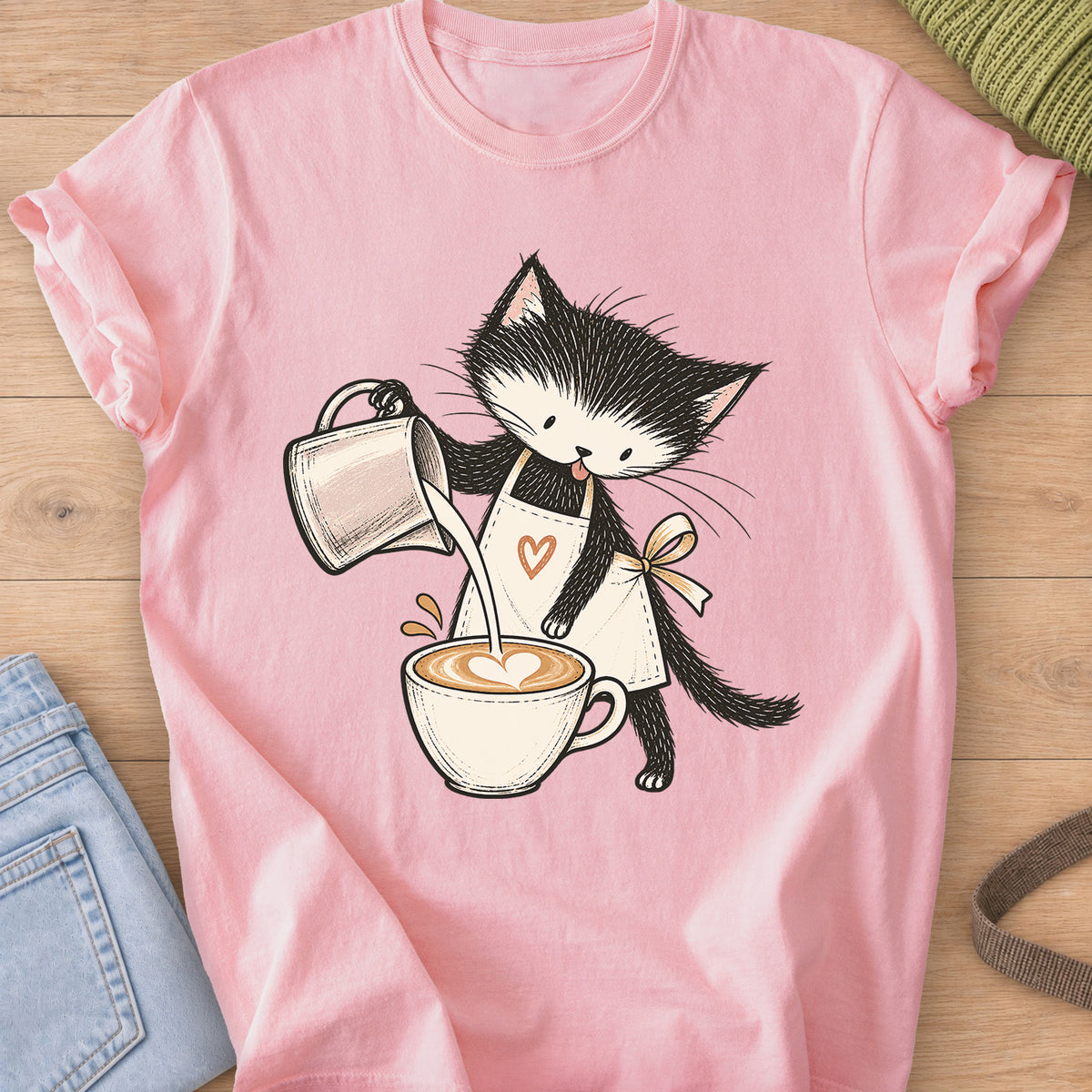 Black and white kitten in an apron pouring milk into a latte with a foam heart on a Blossom T-Shirt