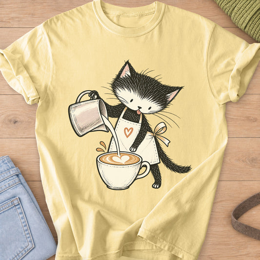 Black and white kitten in an apron pouring milk into a latte with a foam heart on a Butter T-Shirt