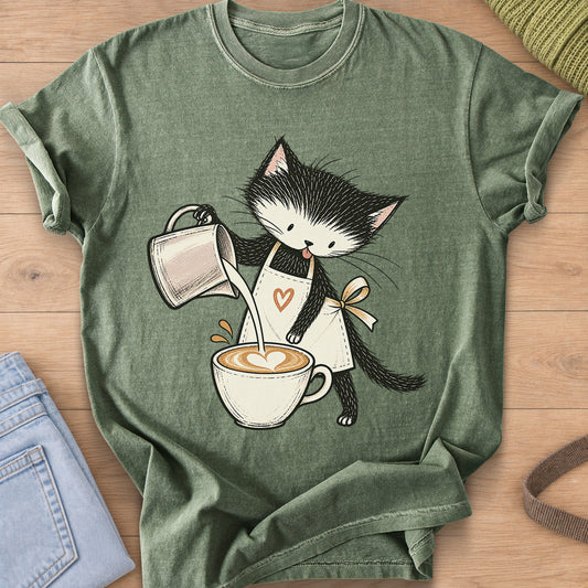 Black and white kitten in an apron pouring milk into a latte with a foam heart on a Moss T-Shirt