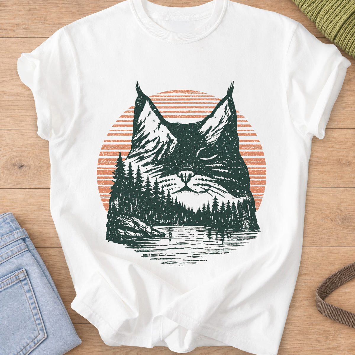 Cat face with closed eyes filled with mountains, pines, a lake and sun, dark green and coral ink on a White T-Shirt