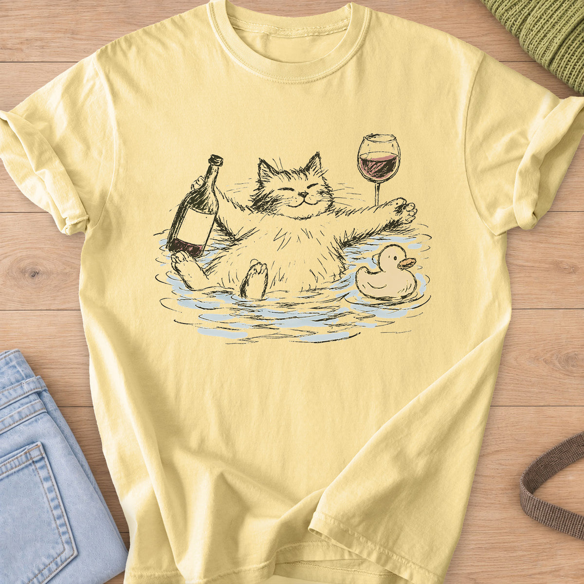 Smiling fluffy cat soaking in a bath with wine bottle, wine glass and rubber duck on a Butter T-Shirt