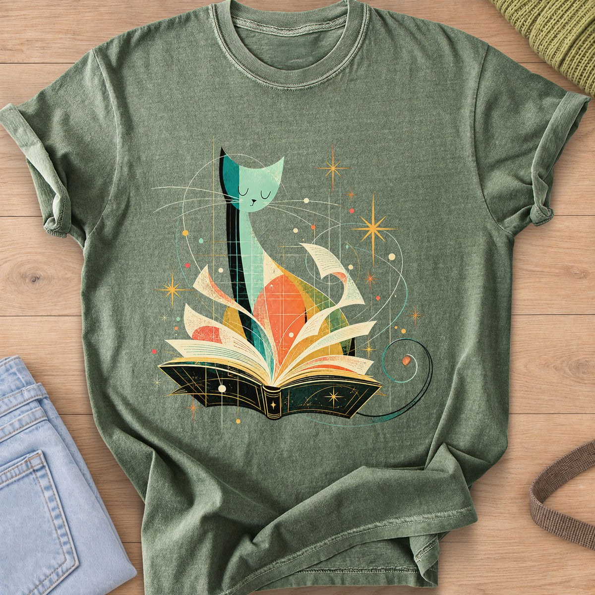 Tall slender cat with closed eyes behind an open book, flying pages and stars on a Moss T-Shirt