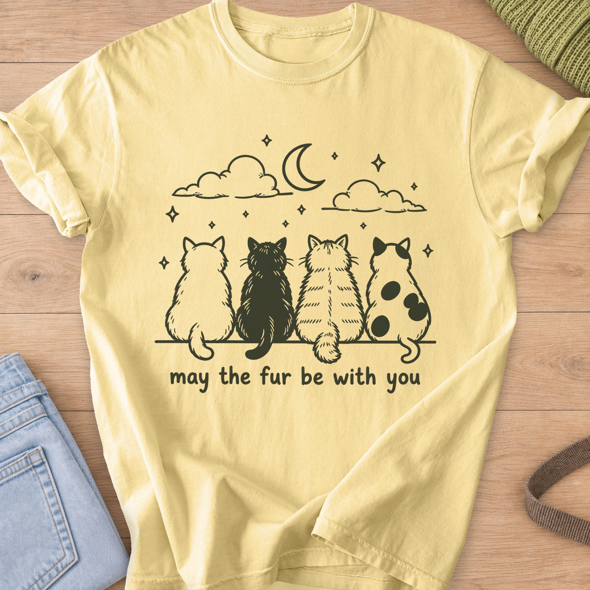 Four cats from behind gaze at a crescent moon and stars, "may the fur be with you", dark charcoal ink on a Butter T-Shirt