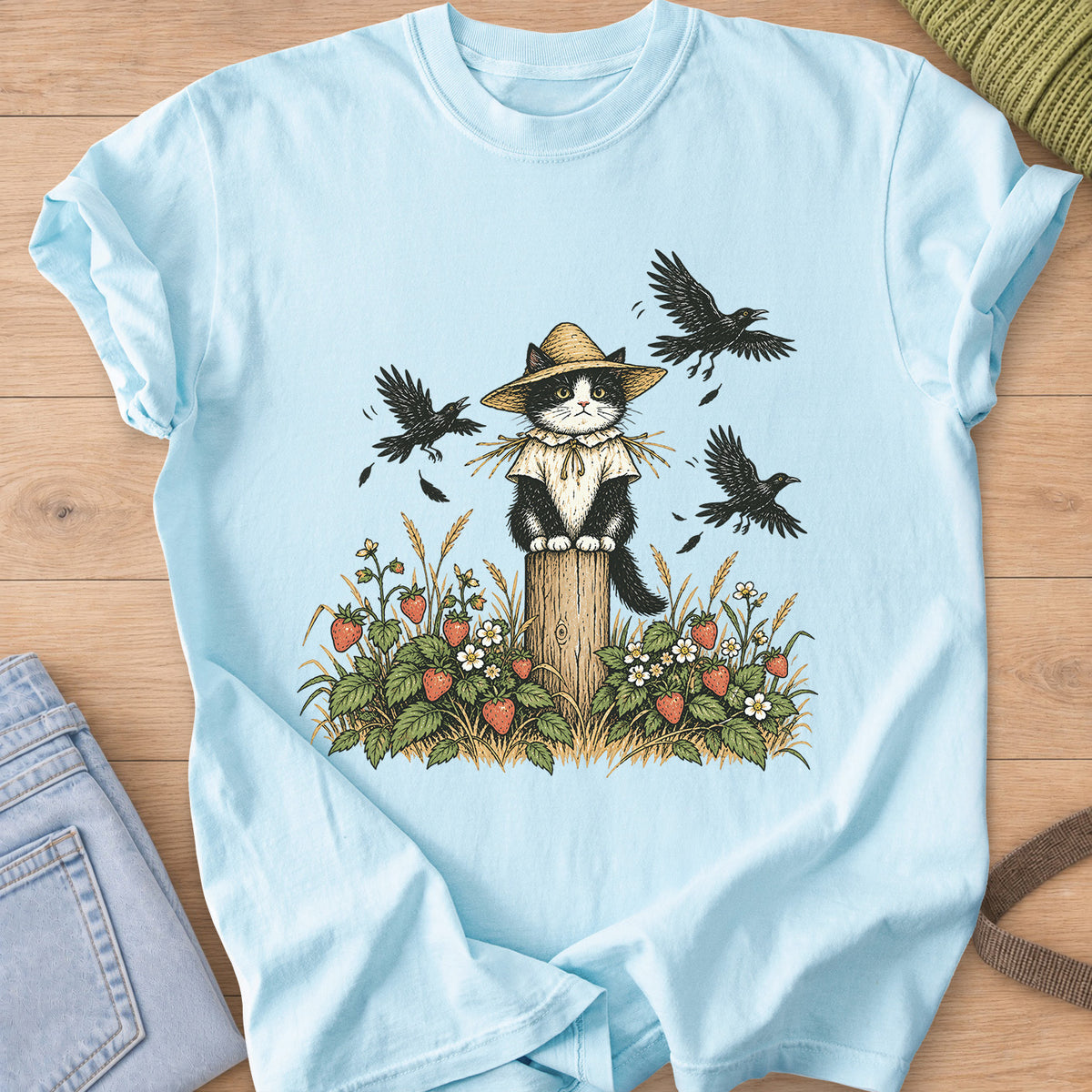 Tuxedo cat in a straw hat as a scarecrow on a post, strawberry plants and crows on a Chambray T-Shirt