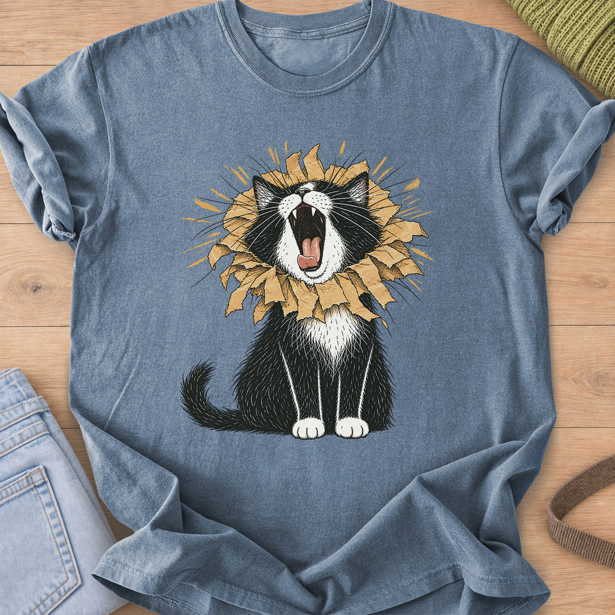 Tuxedo cat roaring with a torn paper bag mane like a lion, sunburst rays behind on a Blue Jean T-Shirt