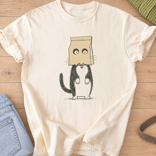 Cat standing on hind legs with a paper bag on its head, eyes peering through holes on an Ivory T-Shirt
