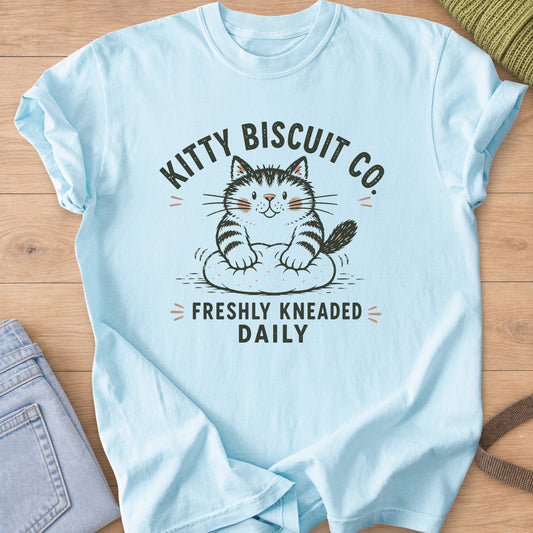 Smiling tabby cat kneading dough with the words "Freshly Kneaded Daily" on a Chambray T-Shirt