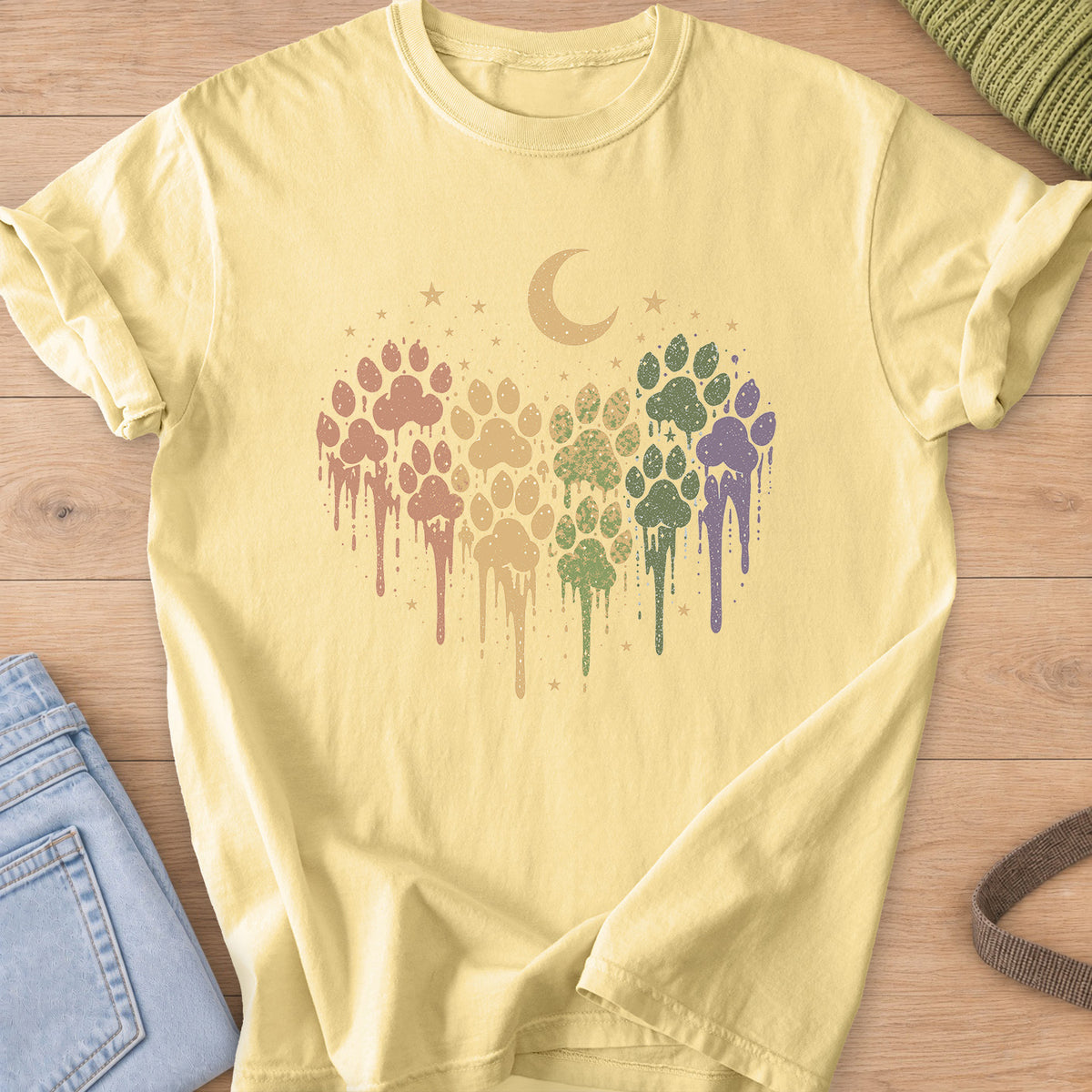 Paw prints in a dripping paint heart under a crescent moon and scattered stars on a Butter T-Shirt
