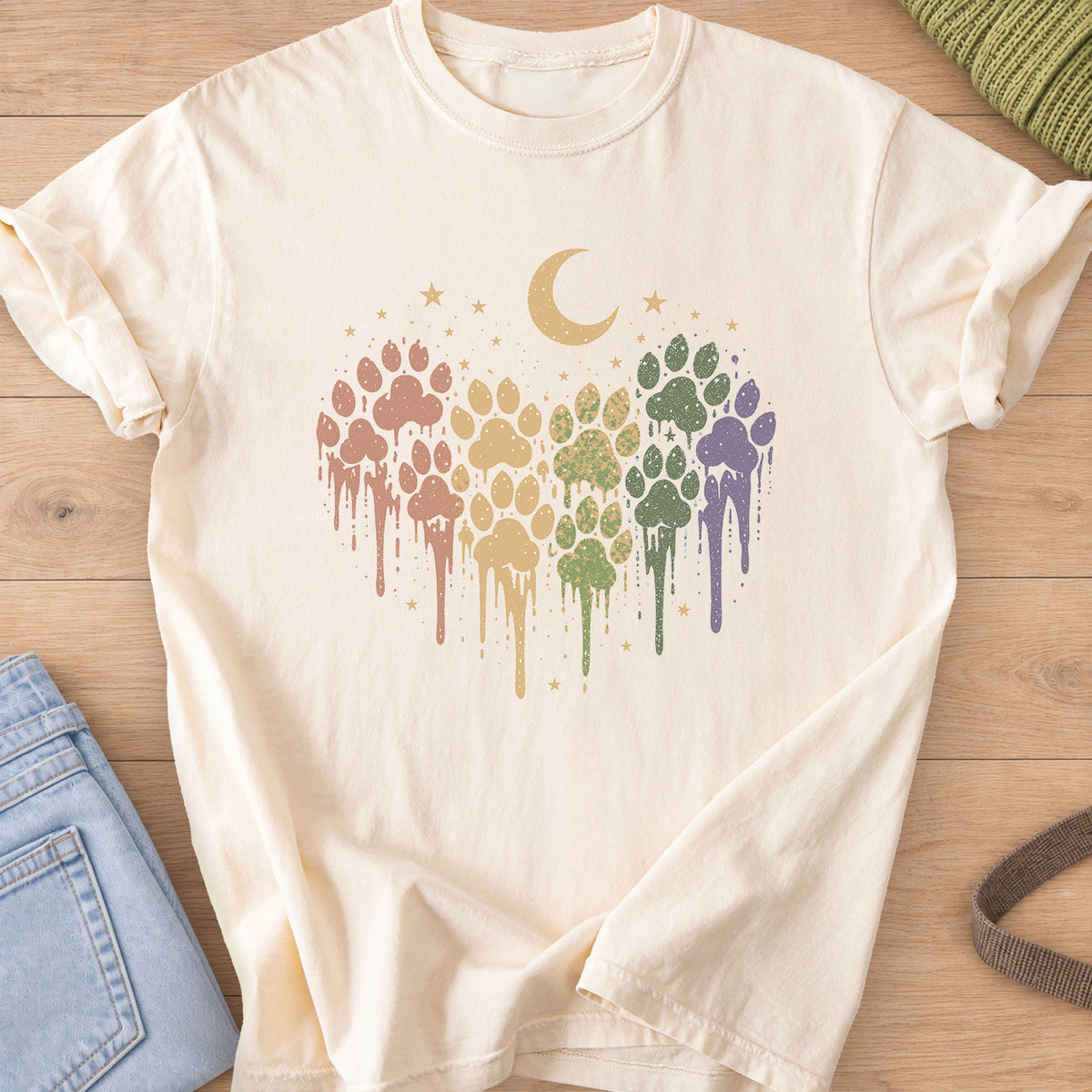 Paw prints in a dripping paint heart under a crescent moon and scattered stars on an Ivory T-Shirt
