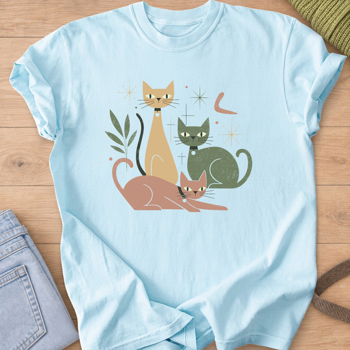 Three mid-century cats with collars posing among starbursts and a leafy sprig on a Chambray T-Shirt