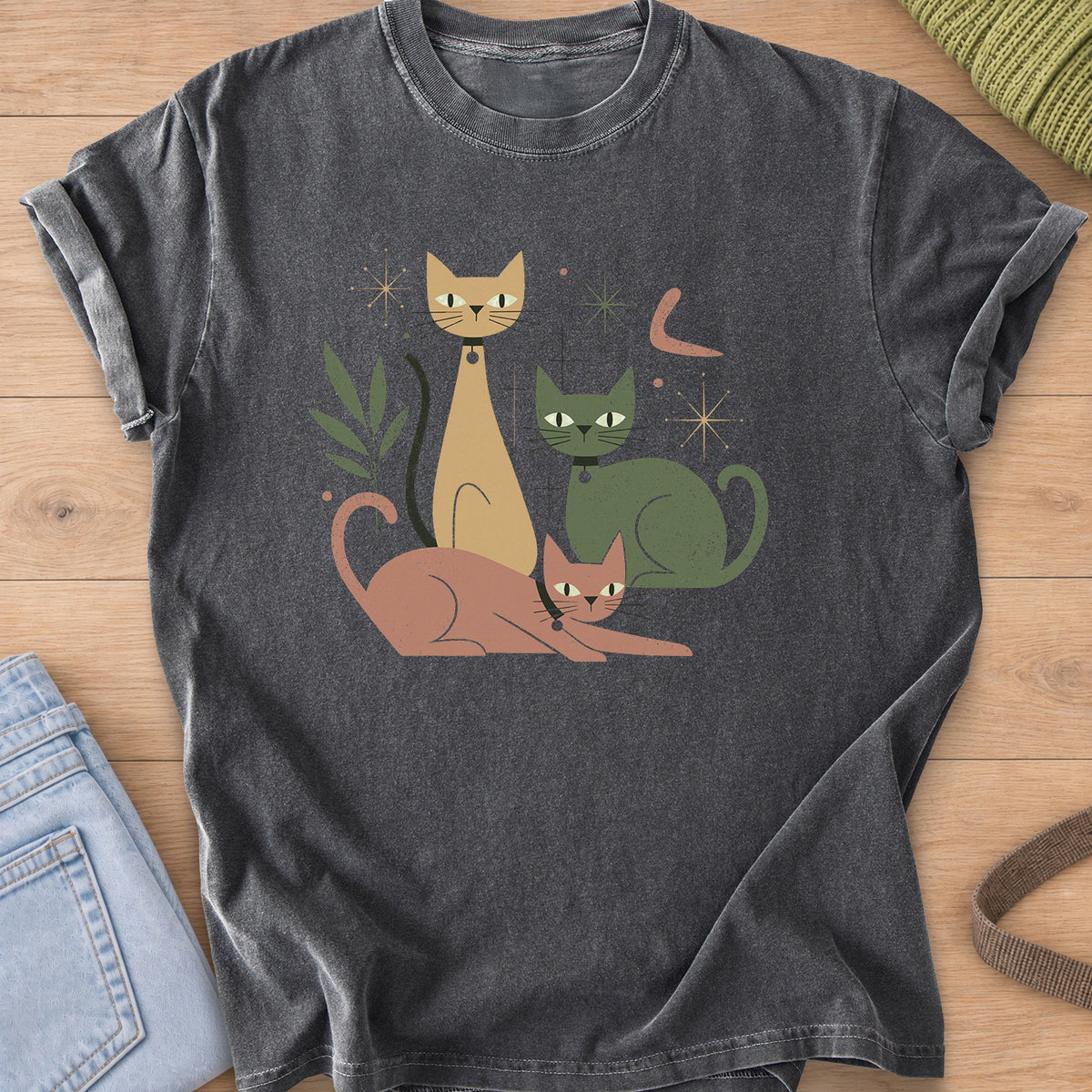 Three mid-century cats with collars posing among starbursts and a leafy sprig on a Pepper T-Shirt