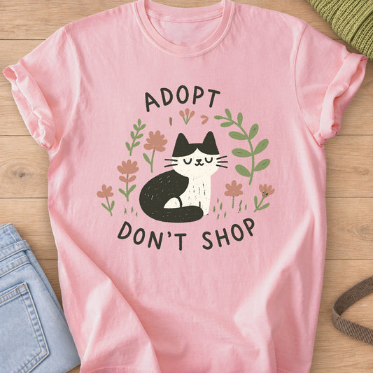 Tuxedo cat sitting with eyes closed among flowers and leaves, "Adopt Don't Shop" on a Blossom T-Shirt