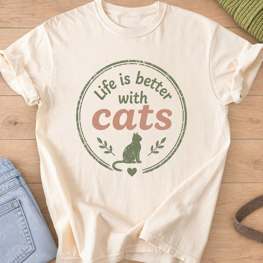 Sitting cat in a round badge reading "Life is better with cats", green and terracotta ink on an Ivory T-Shirt